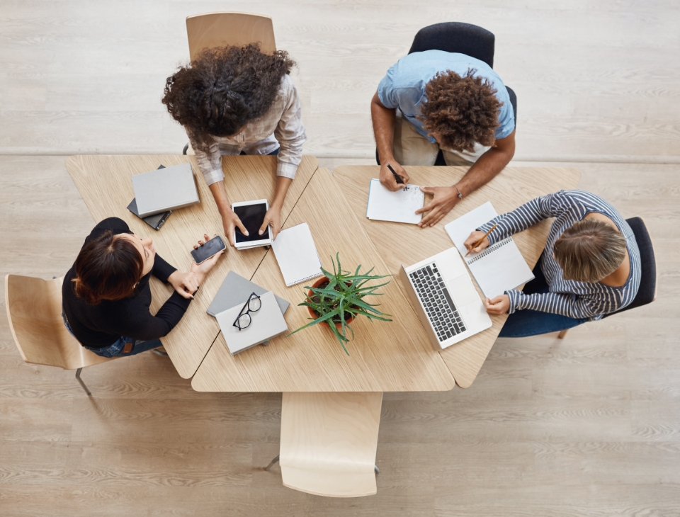 view-from-business-startup-teamwork-concept-startup-partners-sitting-coworking-space-talking-about-future-project-looking-through-examples-work-laptop